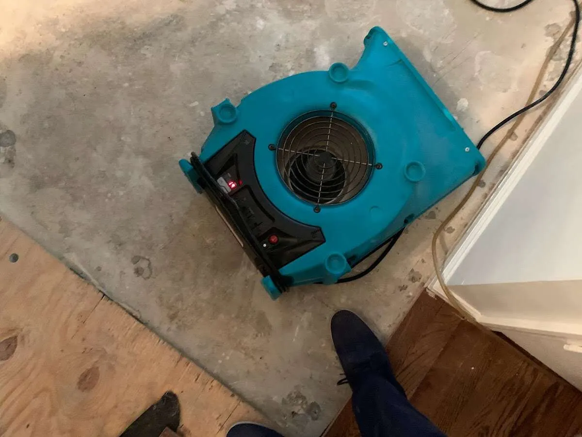 Air mover drying subfloor during Commercial Water Damage Restoration in Golden Gate